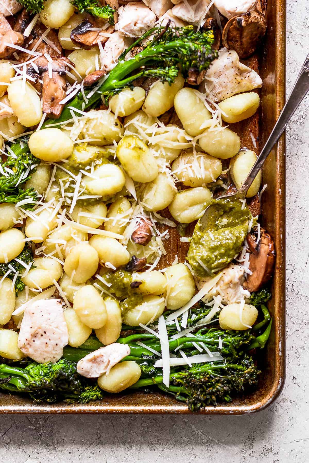 Parmesan cheese and pesto added to the pan.