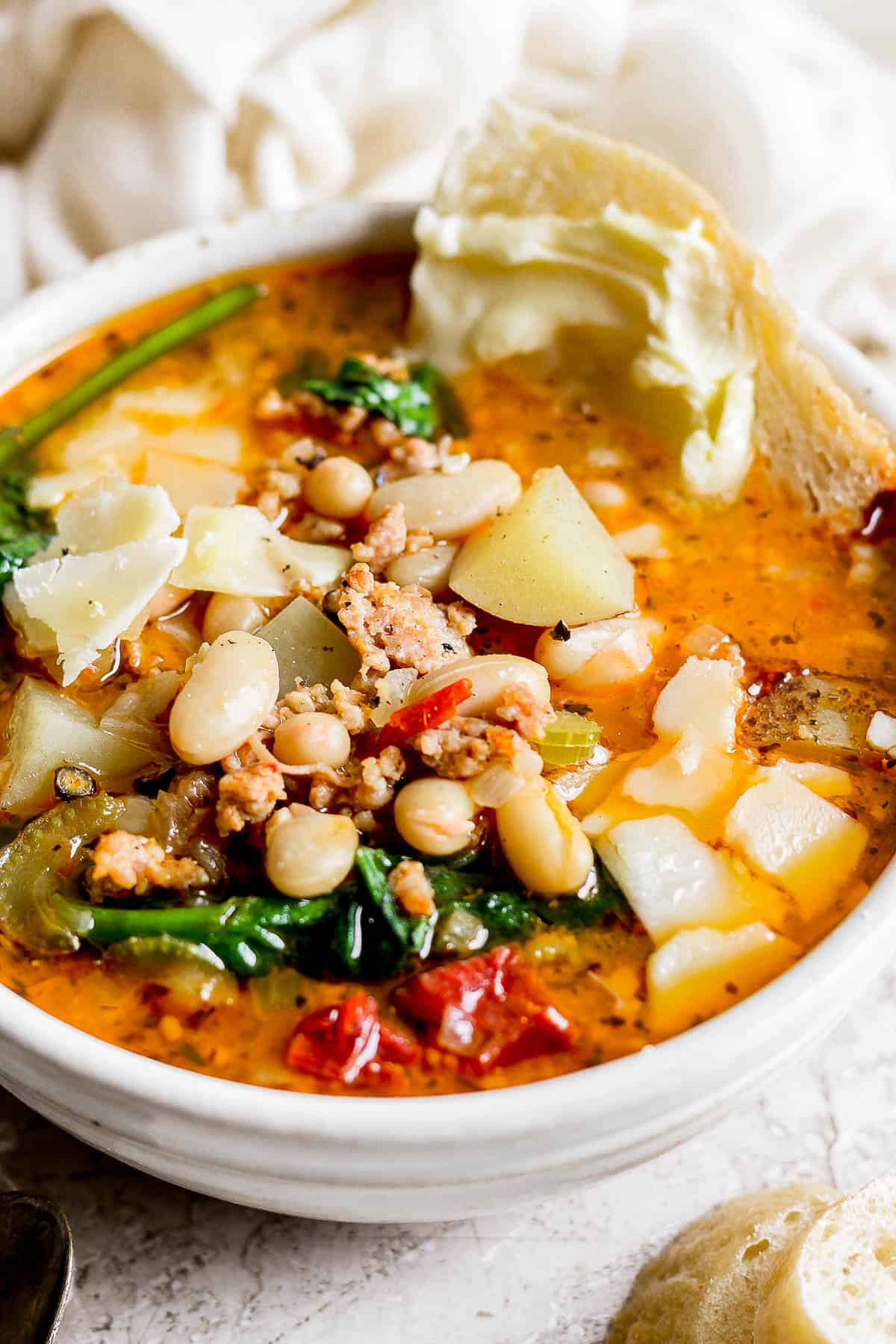 A close up of tuscan white bean soup in a bowl.