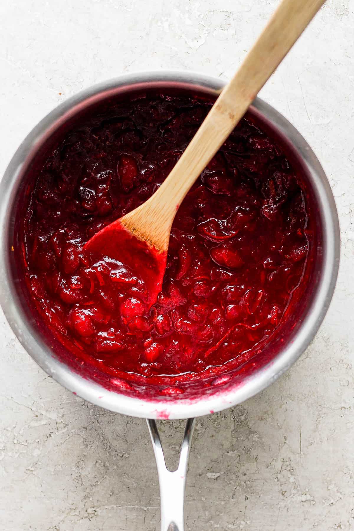 Cooked bourbon cranberry sauce in a sauce pan.