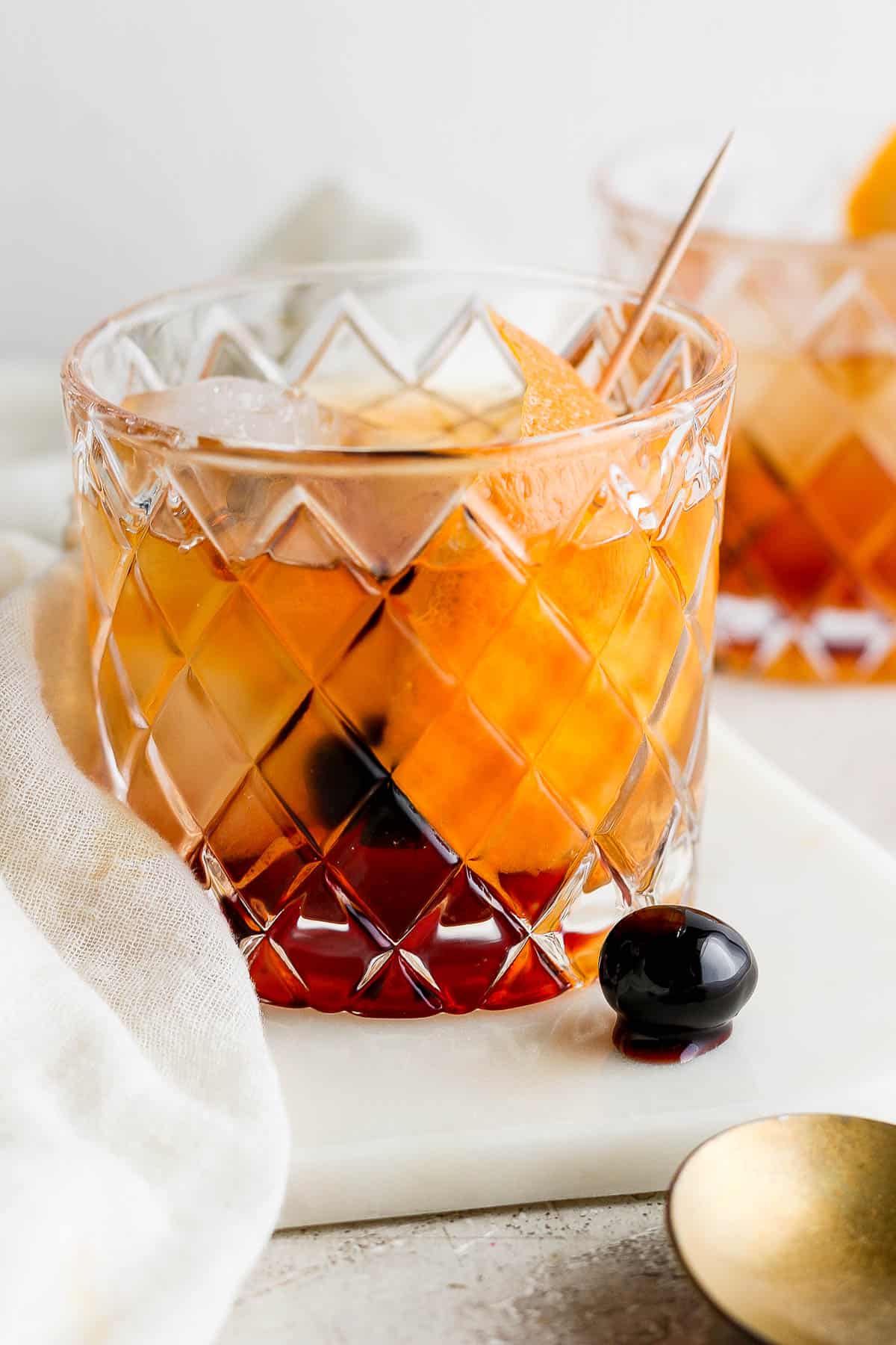 A brandy old fashioned in a low ball glass.
