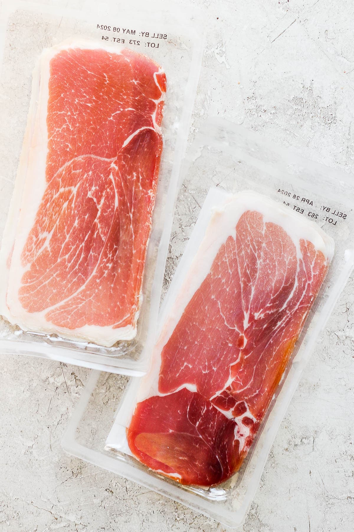 Two packages of prosciutto.