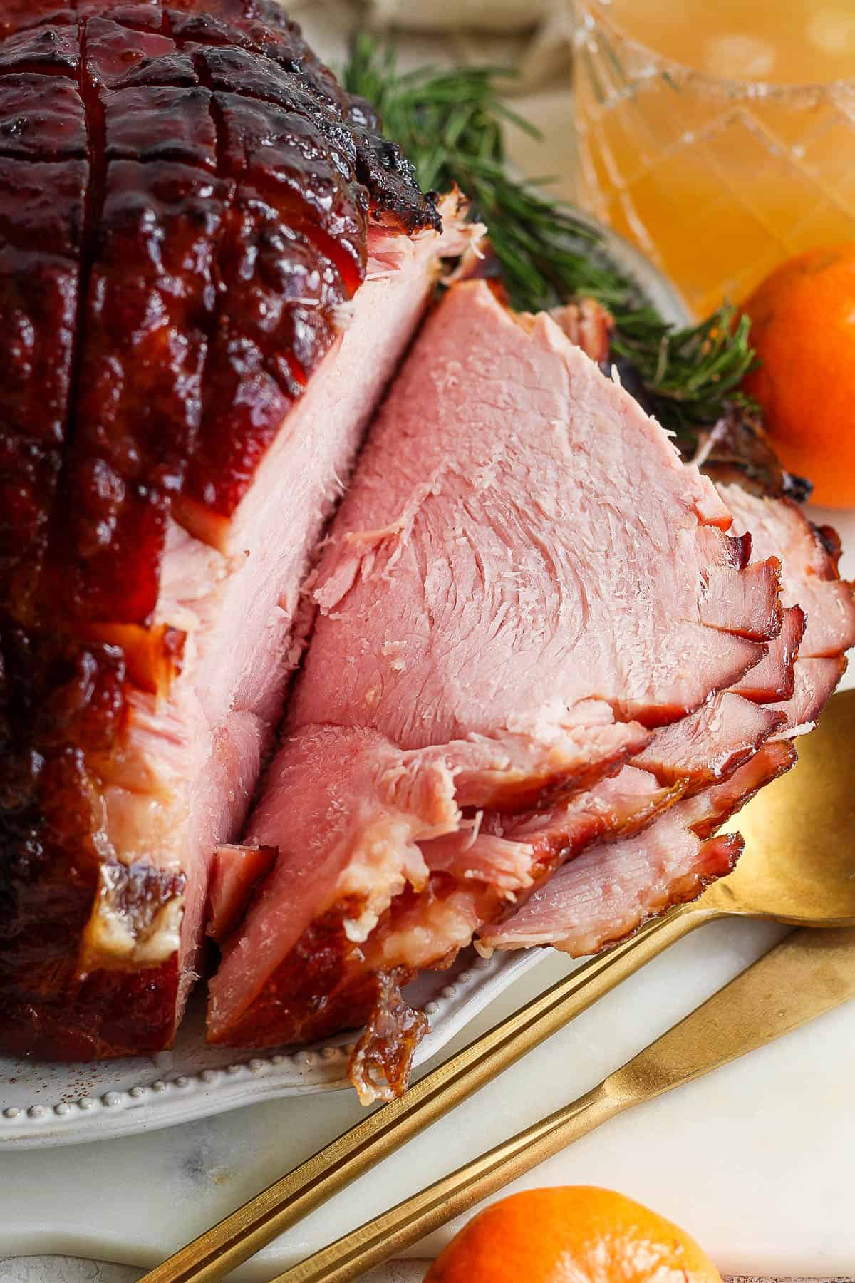 A grilled ham sliced on a platter.