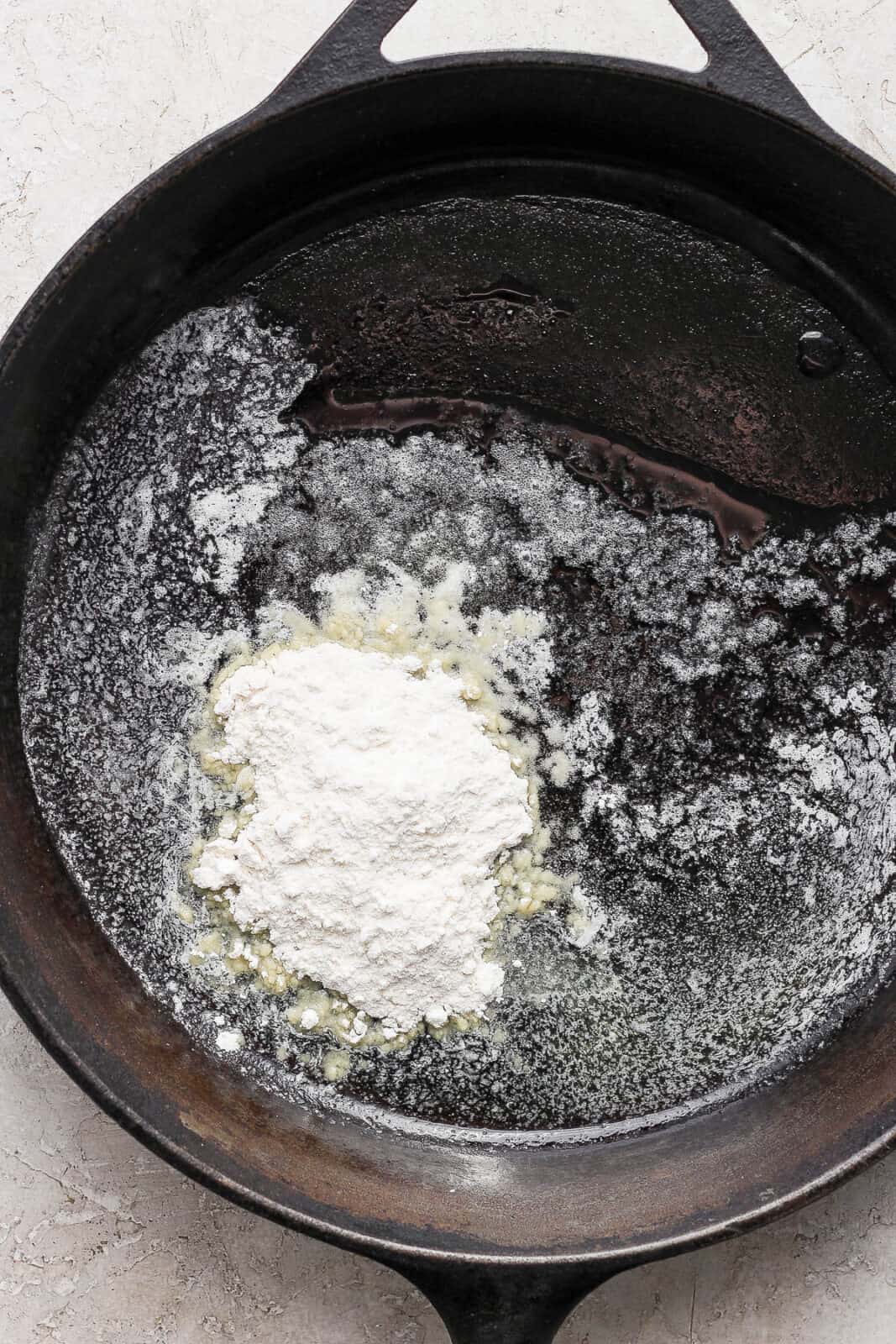 A large skillet with melted butter and flour added.