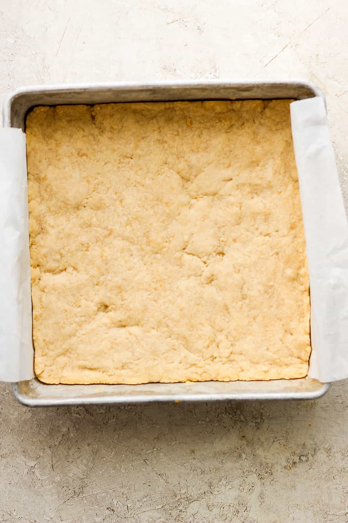 The shortbread filling baked in a parchment-lined baking pan.