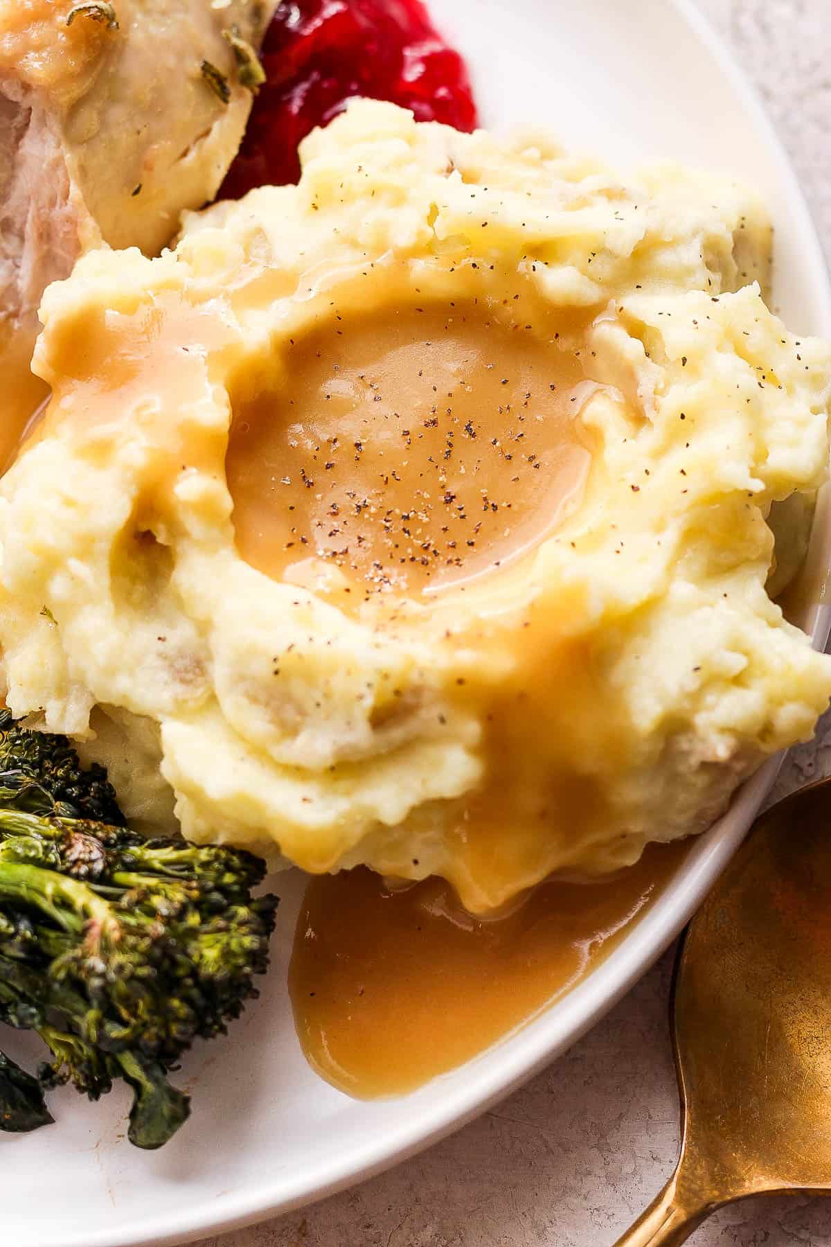 Gravy on top of mashed potatoes.