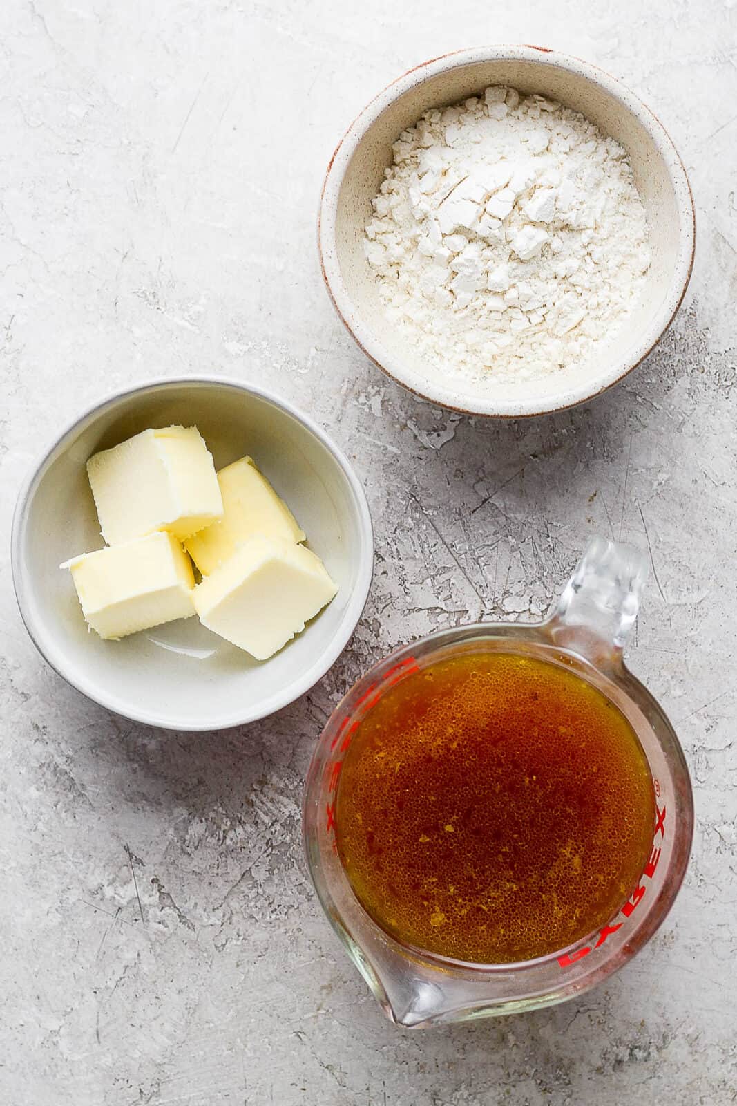 Individual bowls of flour, butter, and turkey trippings.