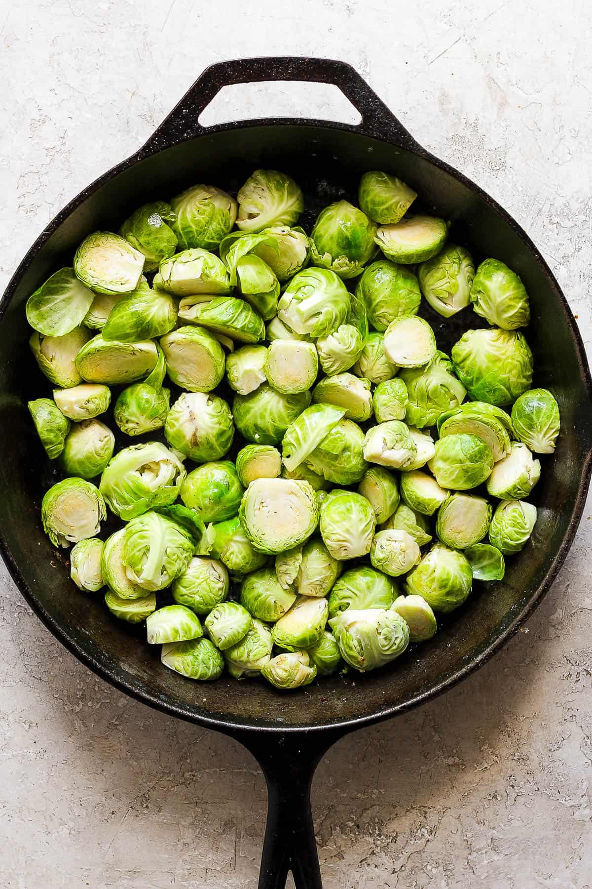 Prepped brussel sprouts in the cast iron skillet.
