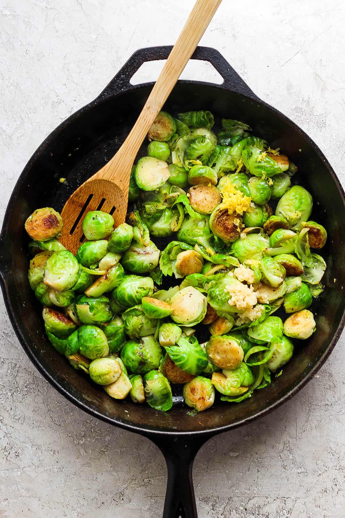cooked brussel sprouts plus lemon zest and minced garlic in the cast iron skillet.