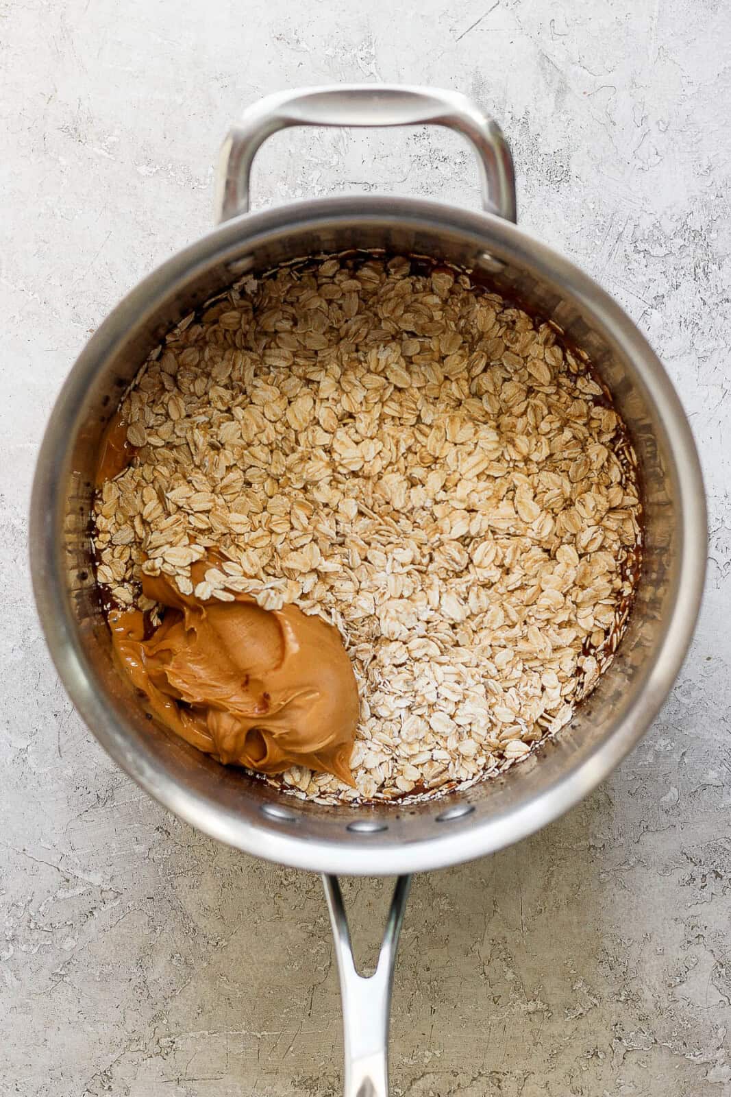 Oatmeal and peanut butter added to cocoa mixture to make No Bake Chocolate Peanut Butter Oatmeal Cookies.