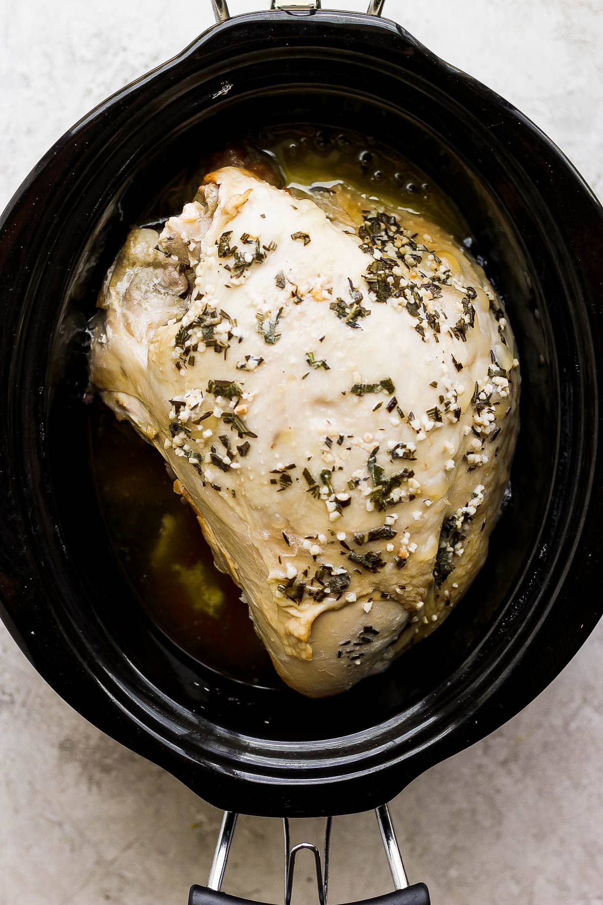 Turkey breast in the slow cooker after being cooked.
