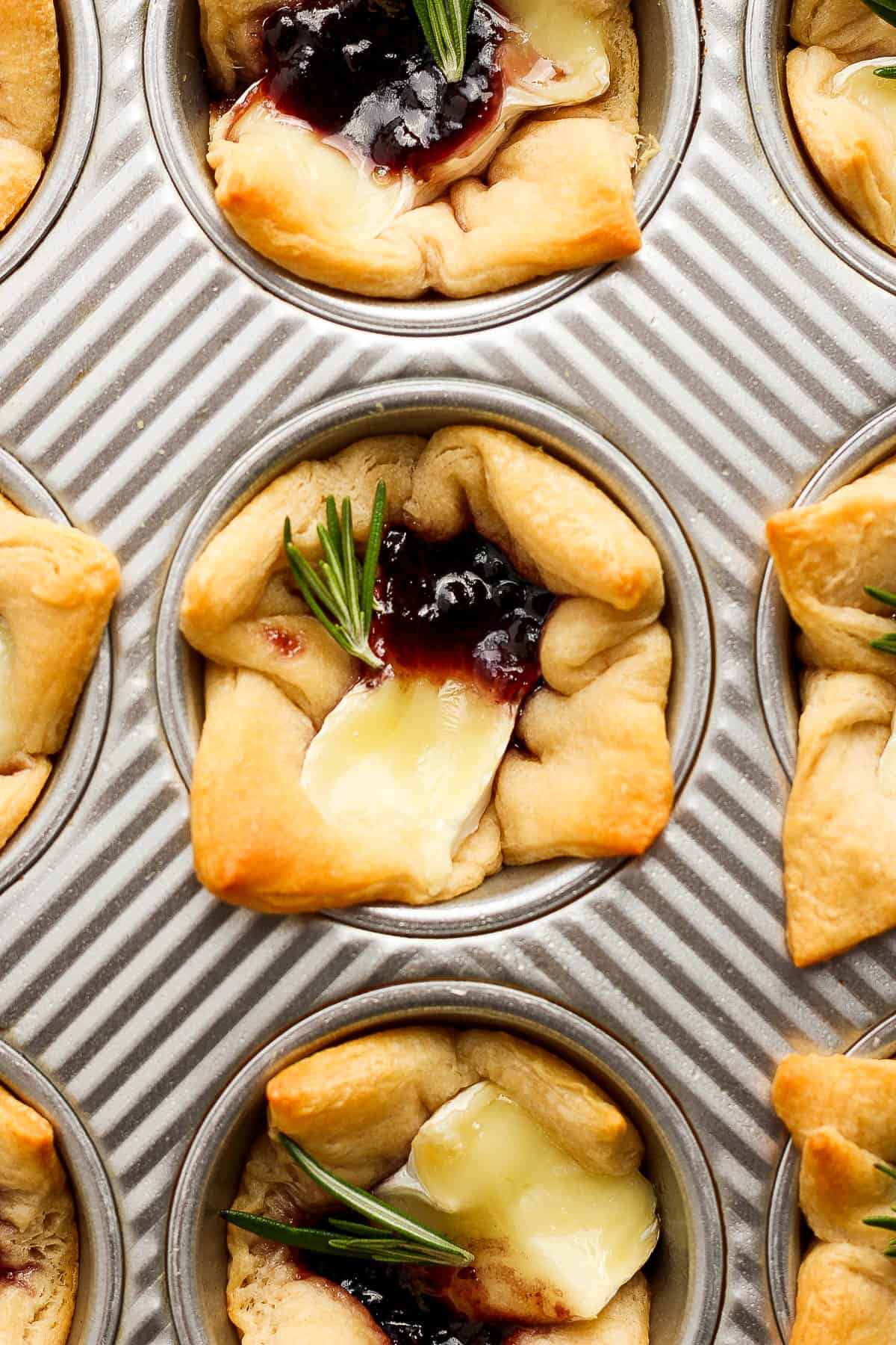 A baked brie bite in a muffin tin.