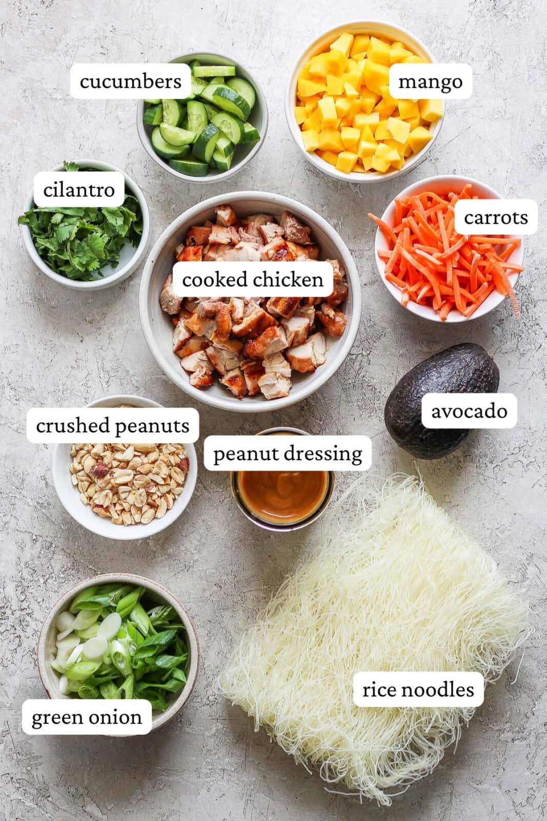 Ingredients for chicken spring roll bowls separated out into bowls and labeled.