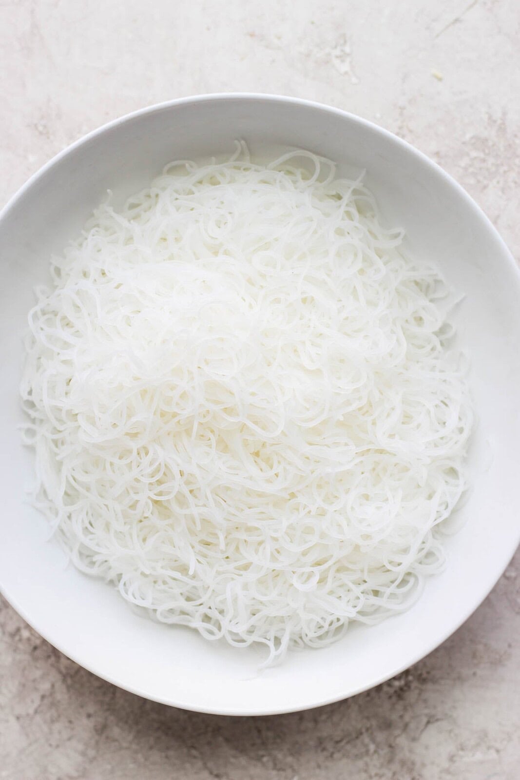 A bowl of cooked thin rice noodles in a bowl.