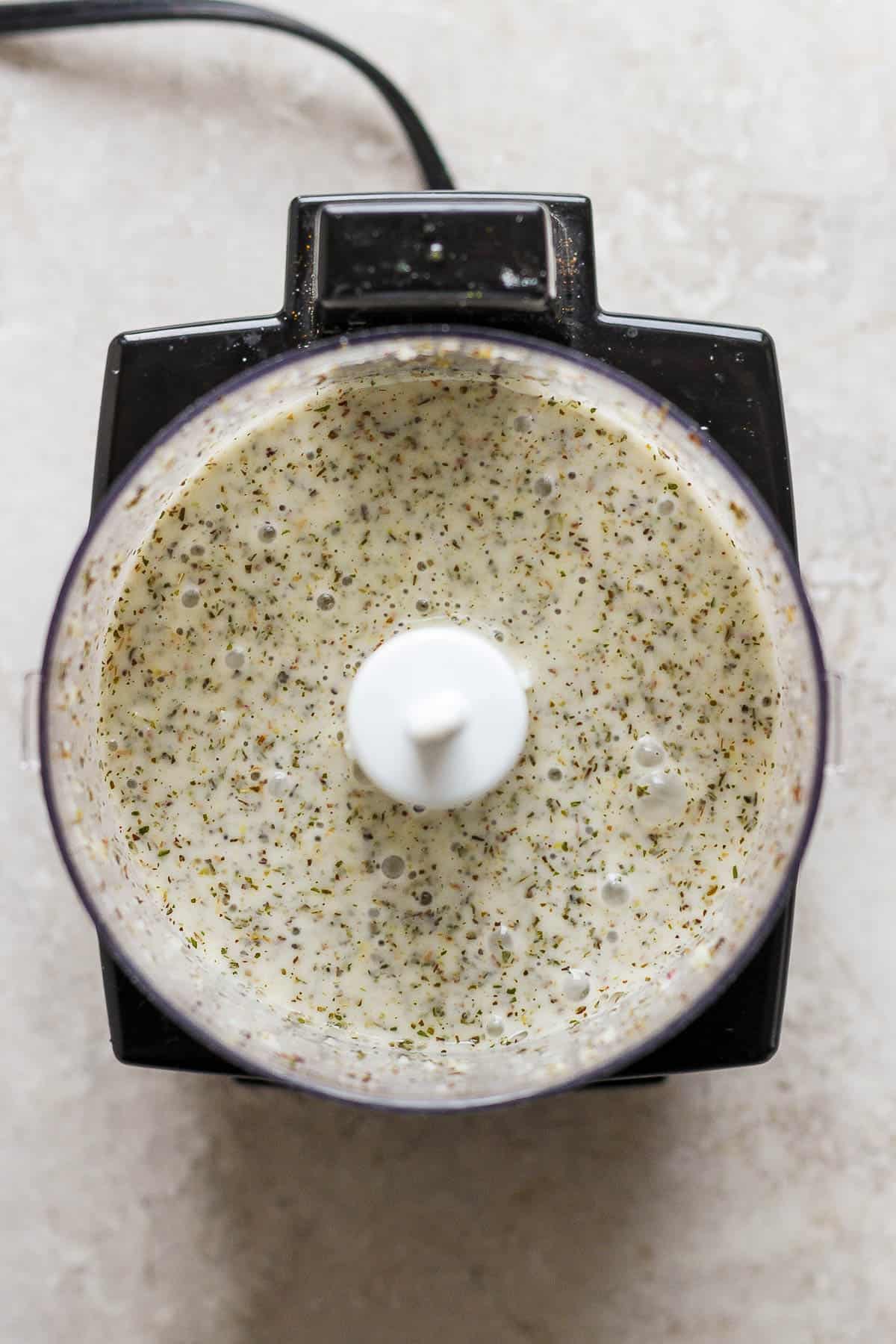A fully blended Italian dressing in a food processor.