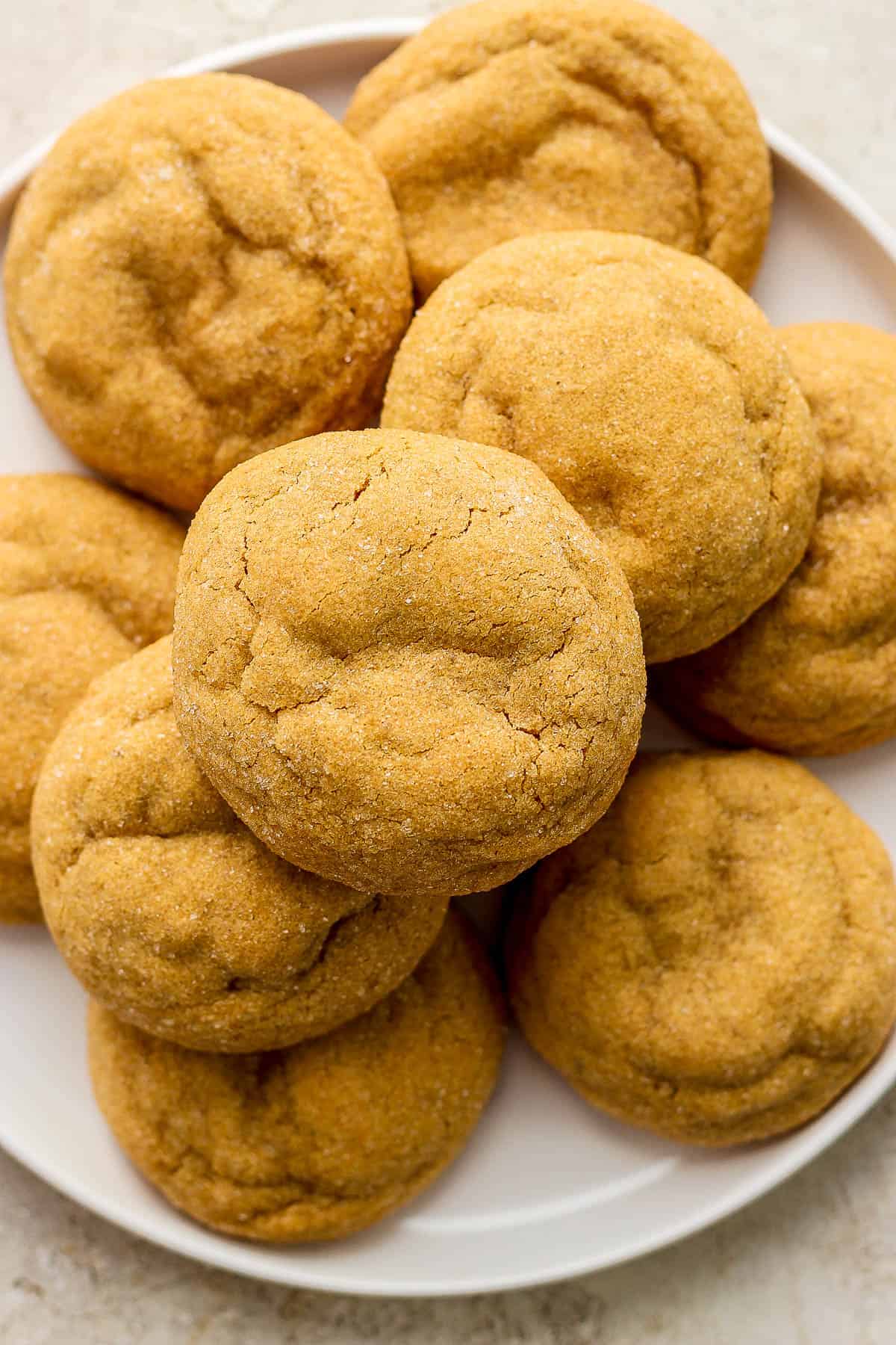 A pile of gluten free molasses cookies on a plate.