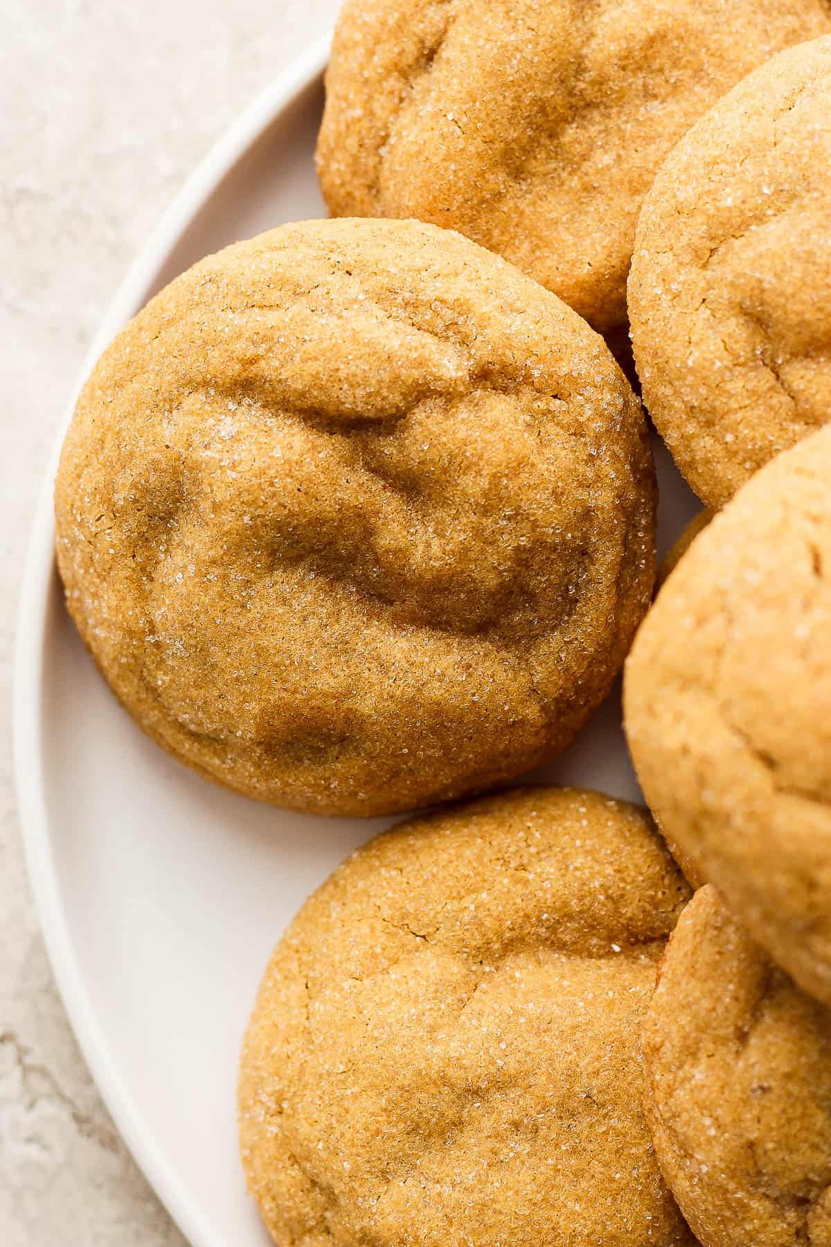 5 gluten-free molasses cookies on a plate.