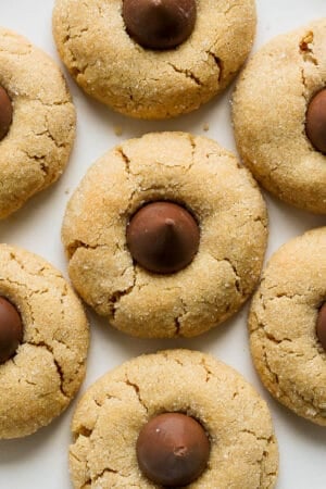 Top down shot of a plate of gluten free peanut butter blossoms.