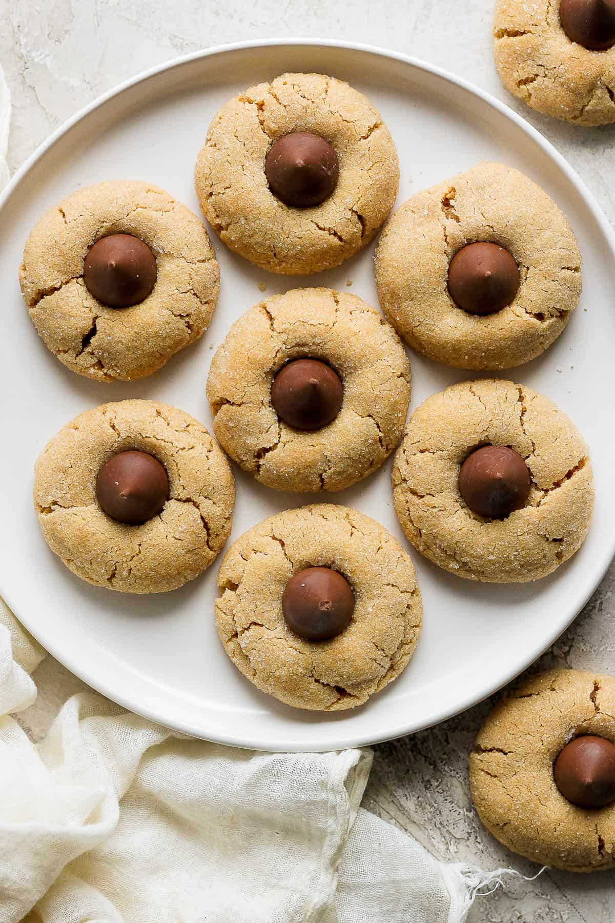 Gluten free peanut butter blossoms on a white plate.