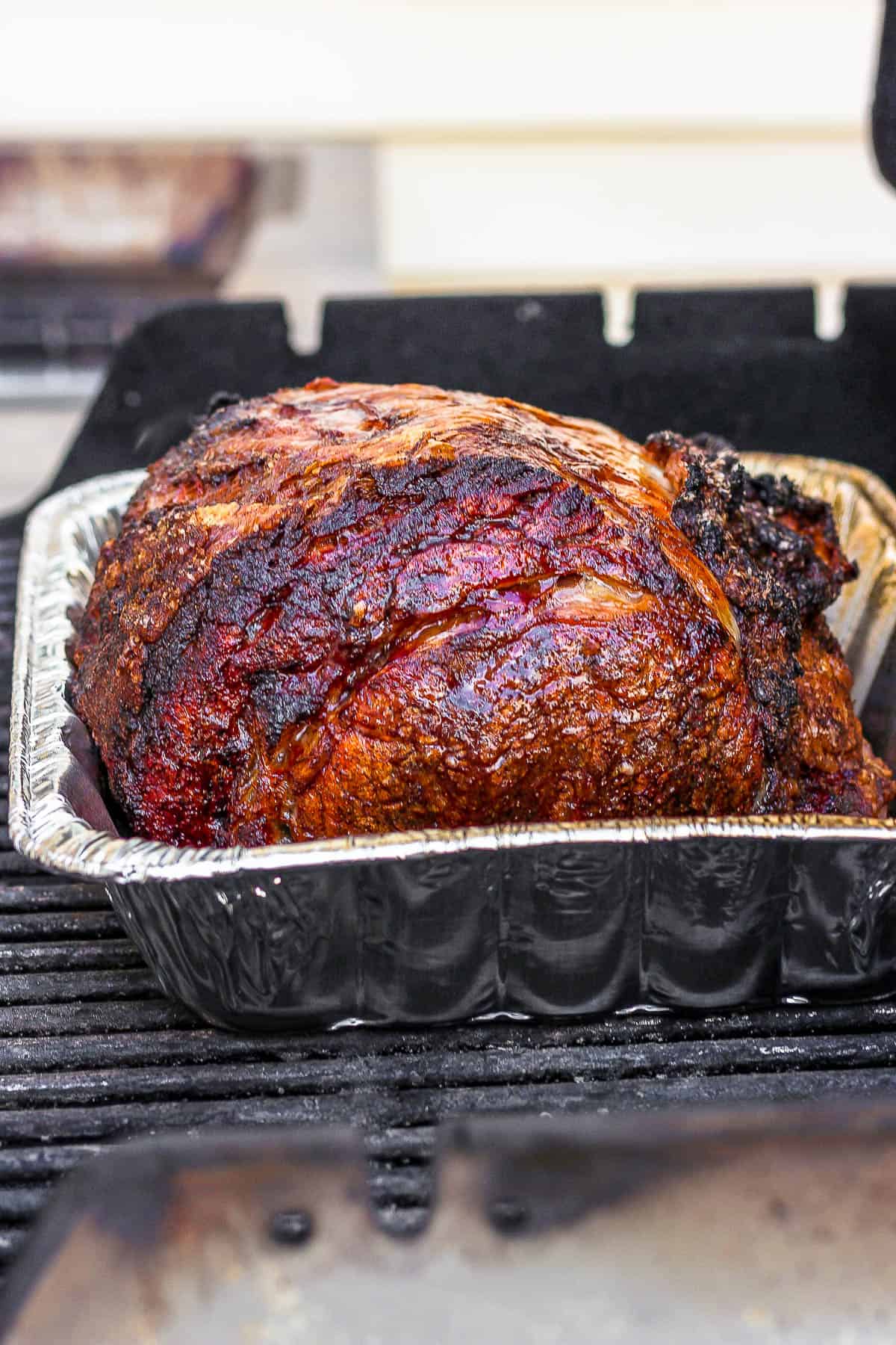 A fully cooked prime rib on the grill.