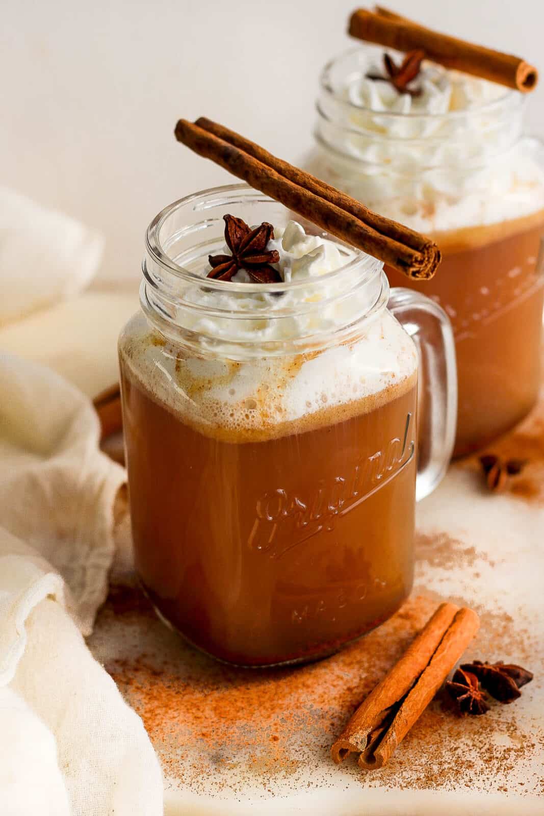Hot buttered rum topped with whipped cream, a star anise, and a cinnamon stick.