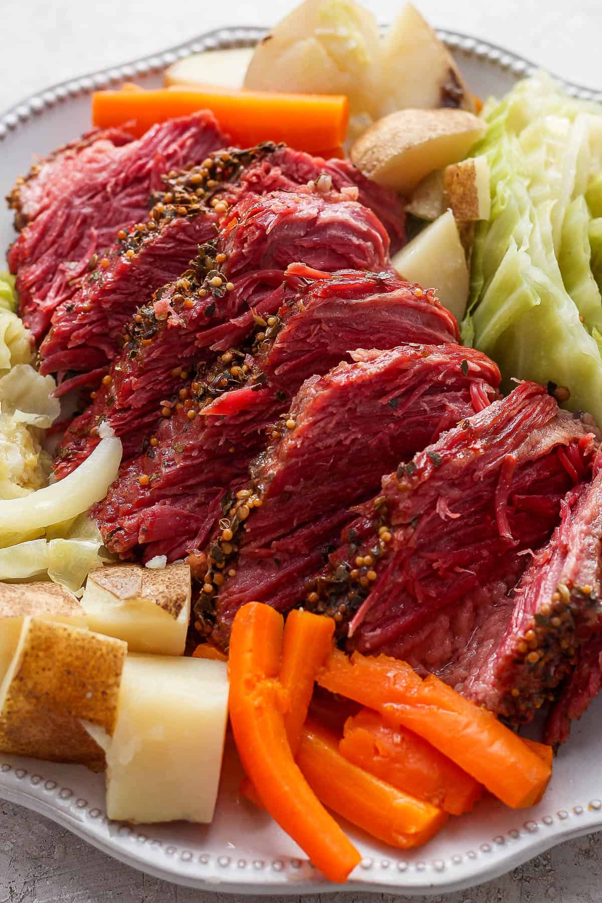 A large platter of corned beef and cabbage.