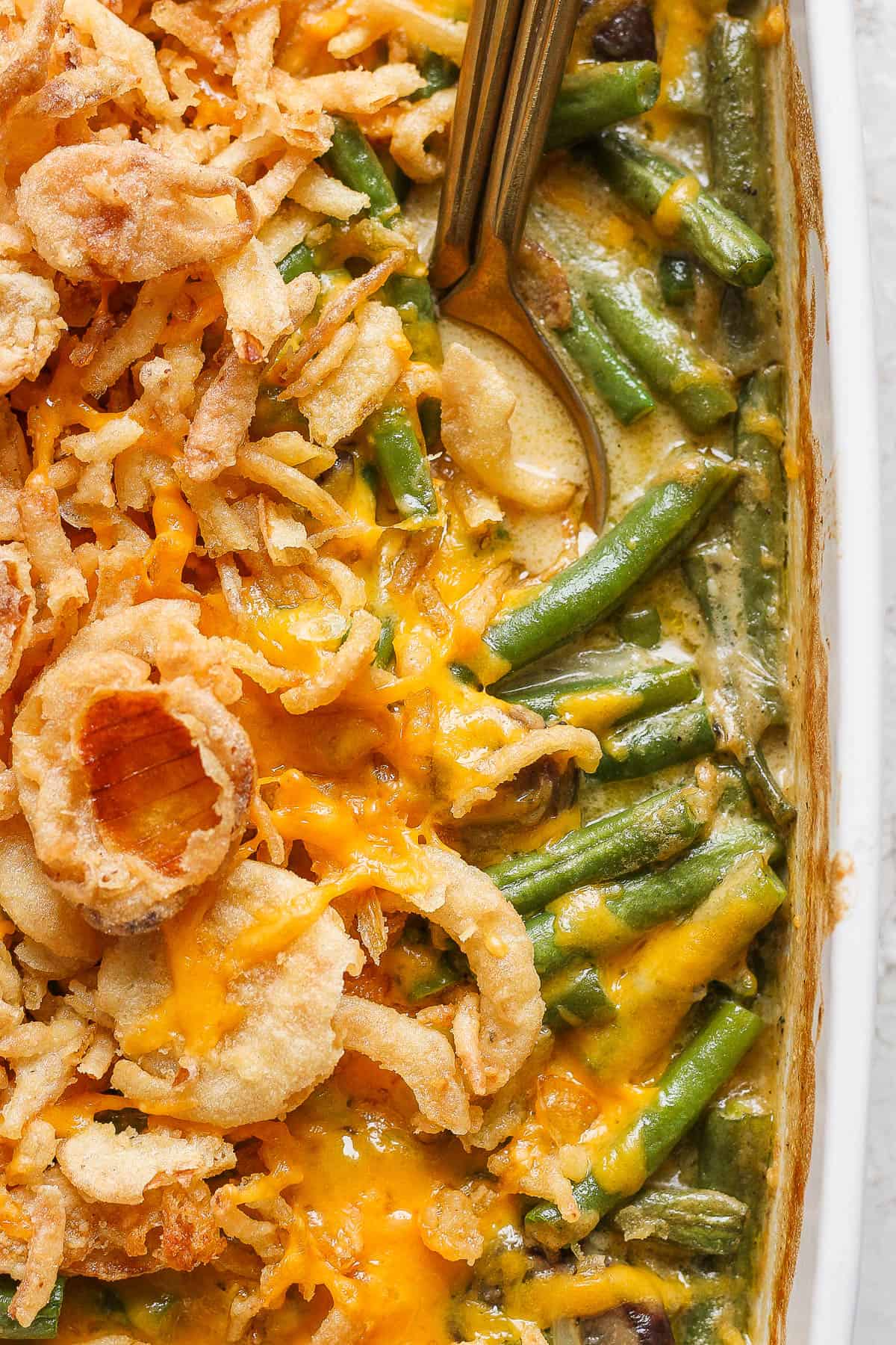 A close-up shot of the baked cheesy green bean casserole.