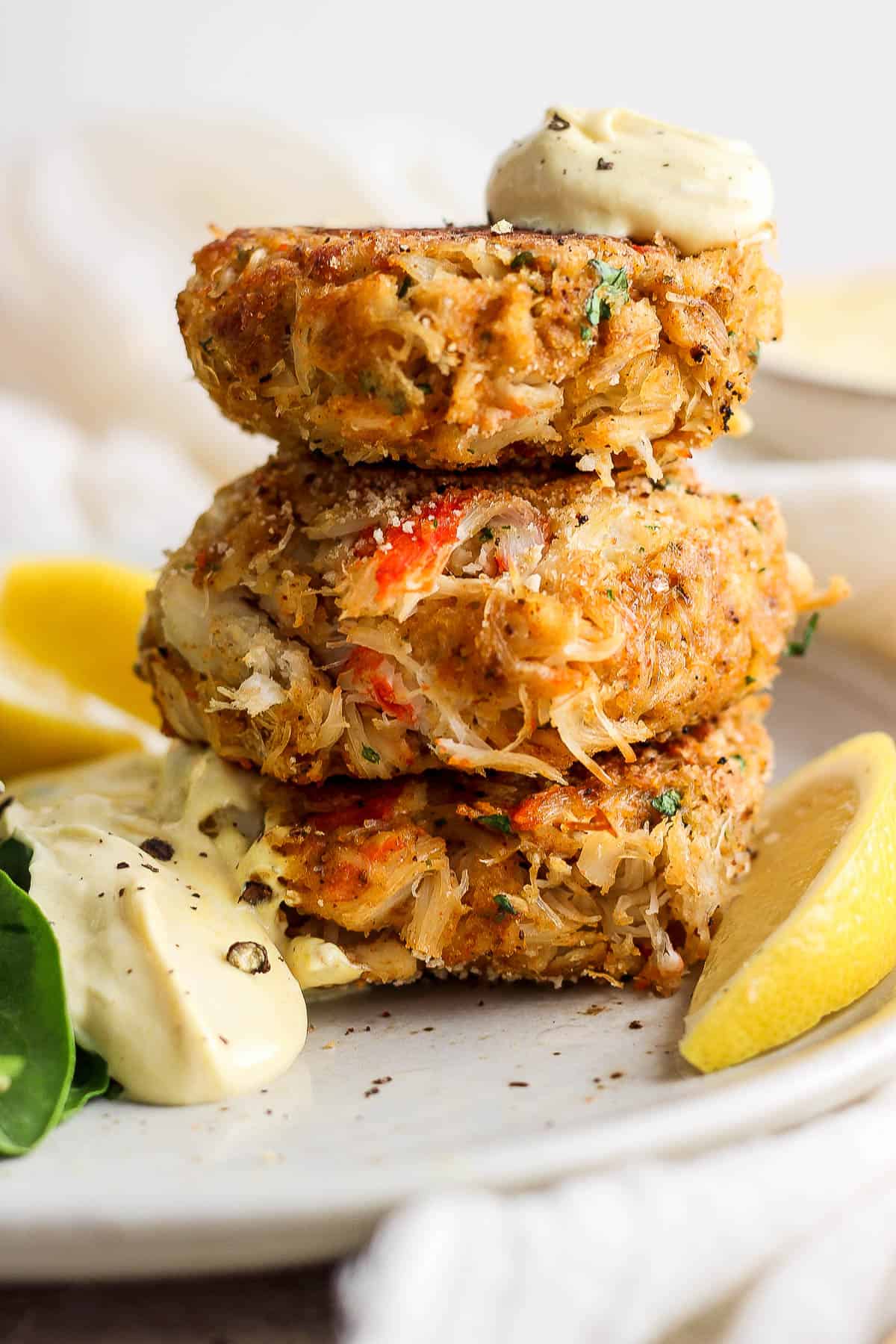 A stack of crab cakes on a plate.