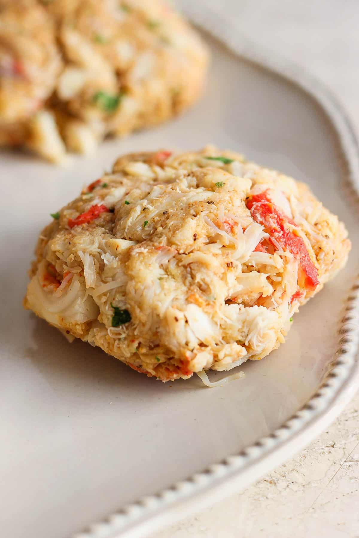 A formed crab cake on a plate.