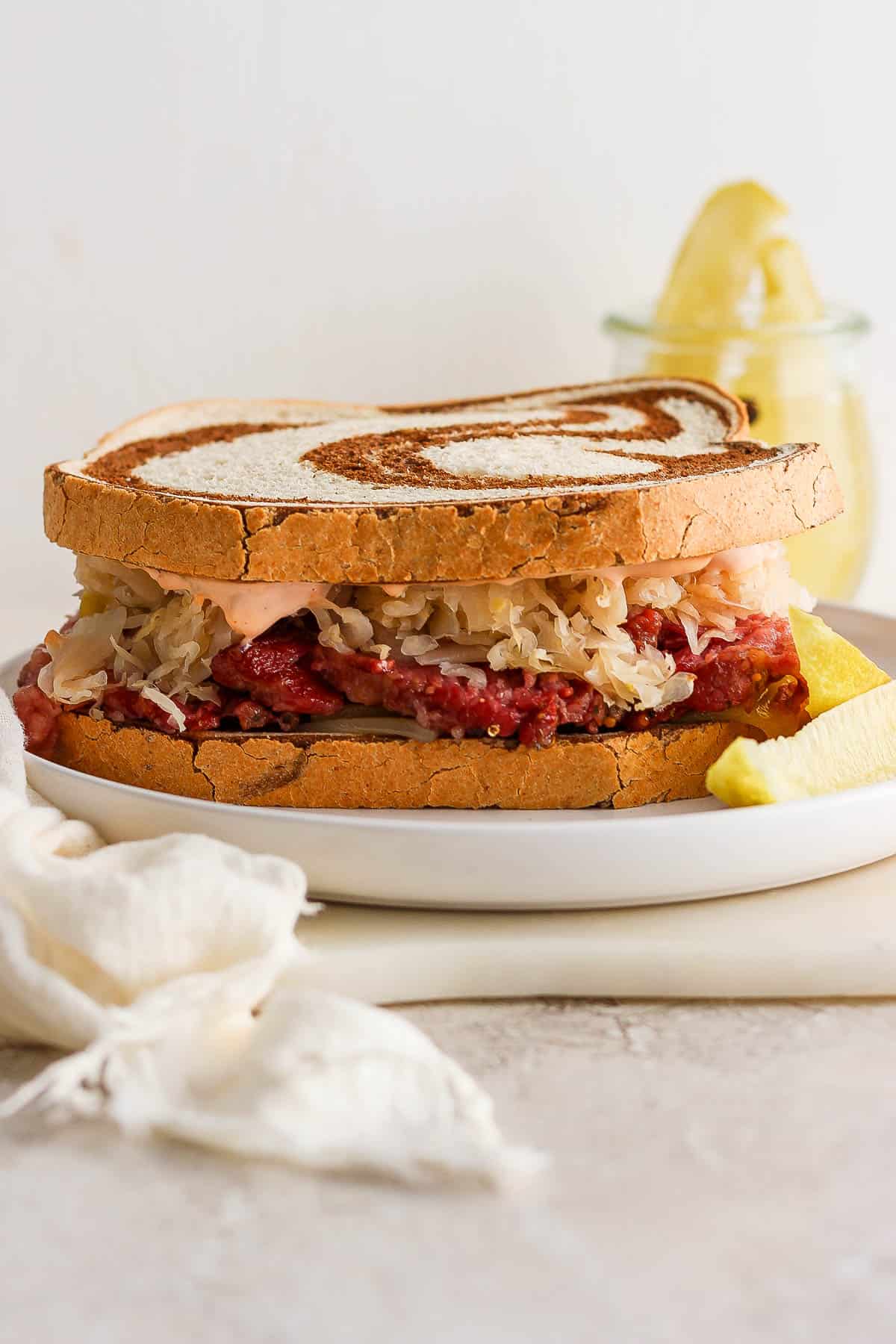A finished reuben sandwich on a plate.