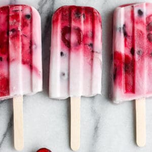 The best recipe for some strawberry, cherry, and cream popsicles.