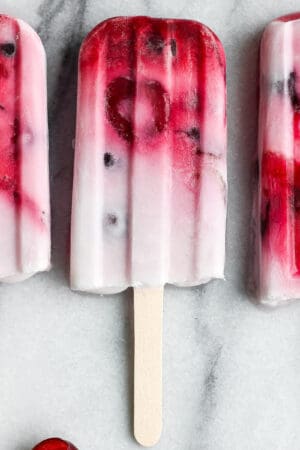 The best recipe for some strawberry, cherry, and cream popsicles.