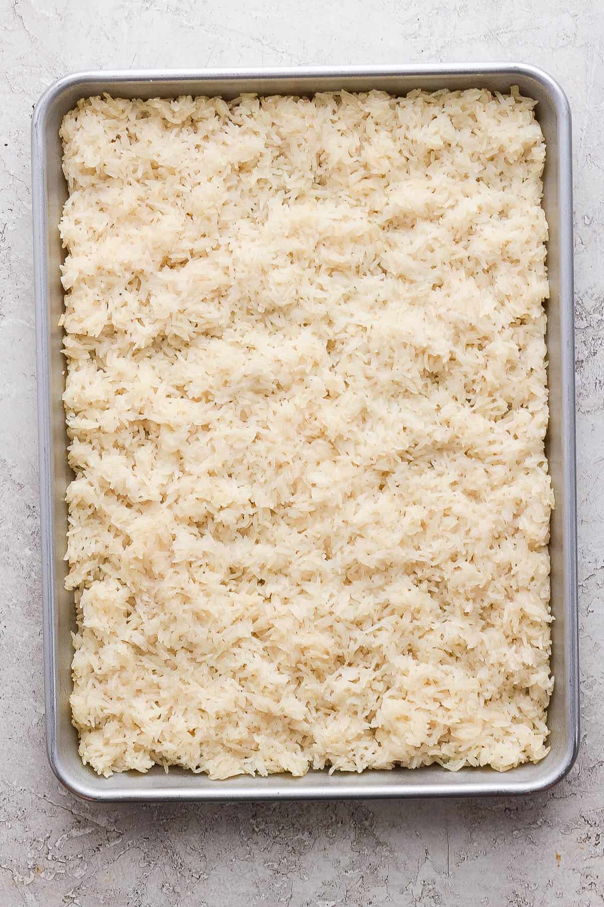 Rice in the baking pan before baking in the oven.