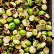 Top down shot of some grilled brussel sprouts on a grill pan.