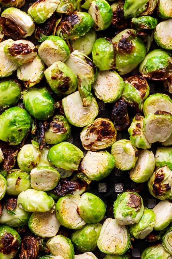 Top down shot of some grilled brussel sprouts on a grill pan.