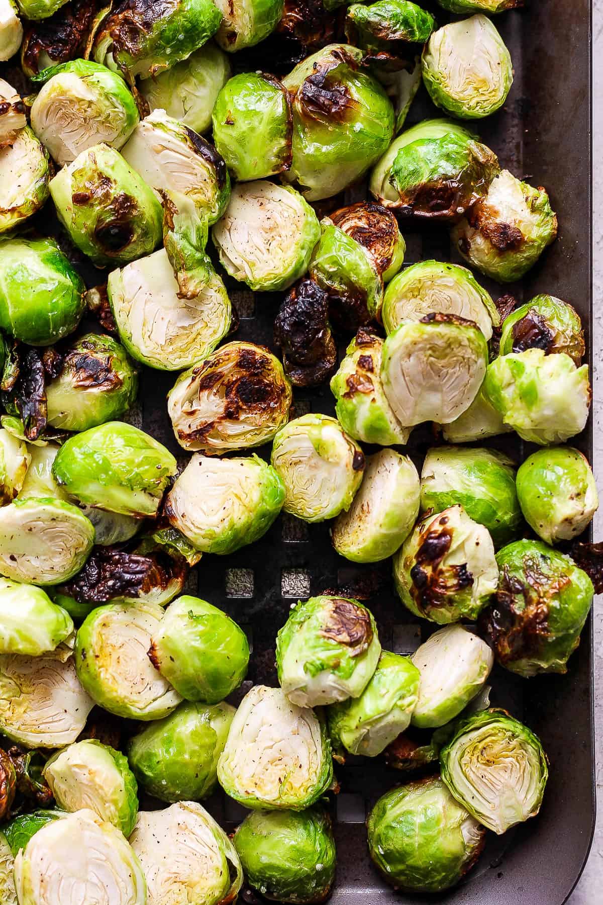 Grilled brussel sprouts on a grill pan.