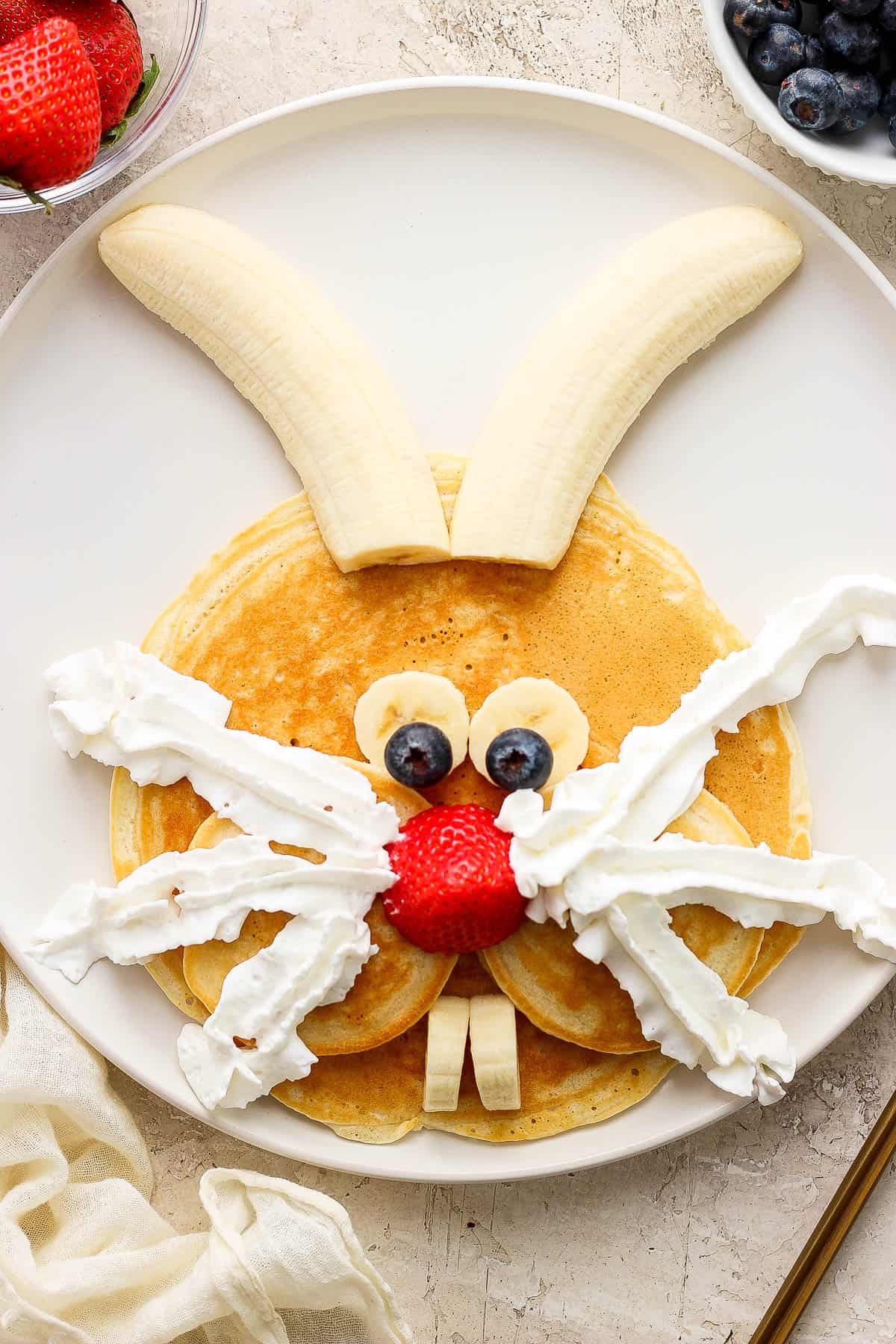A bunny pancake with whipped cream added as whiskers.