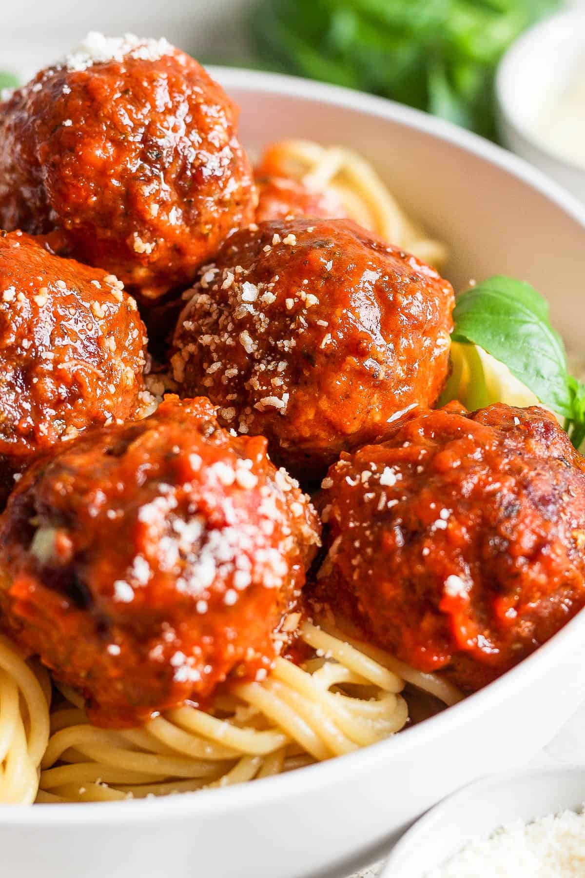 Close-up shot of smoked meatballs in a bowl of noodles.