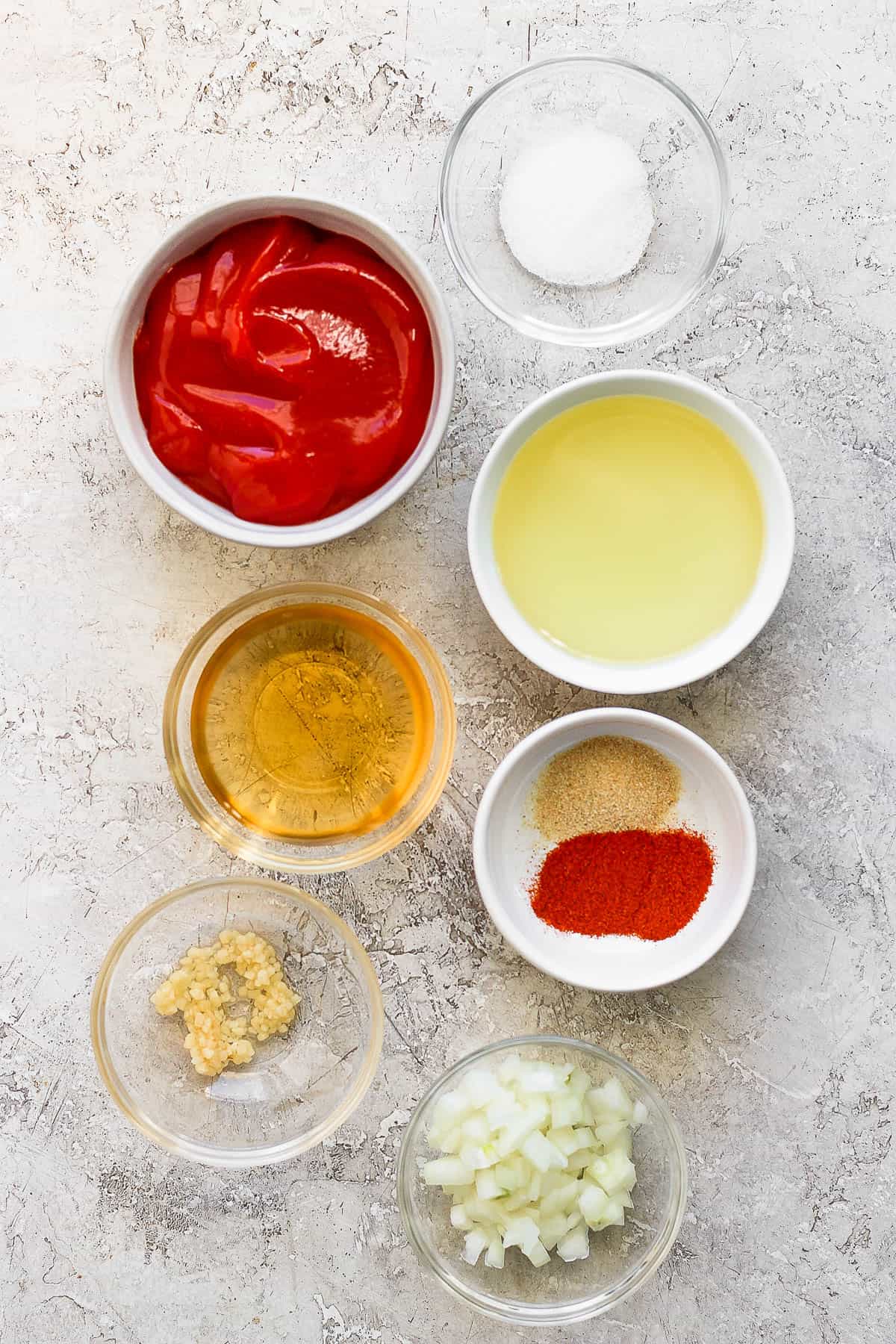 Ingredients for French dressing in separate bowls.