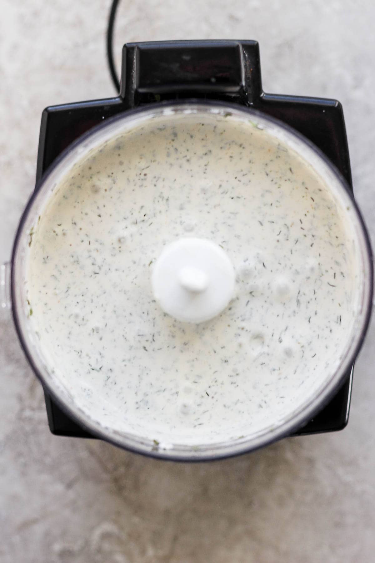 Herby ranch dressing in a small food processor for grilled chicken cobb salad.