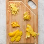 Top down shot of a cutting board showing 5 different ways to zest a lemon.