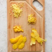Top down shot of a cutting board showing 5 different ways to zest a lemon.