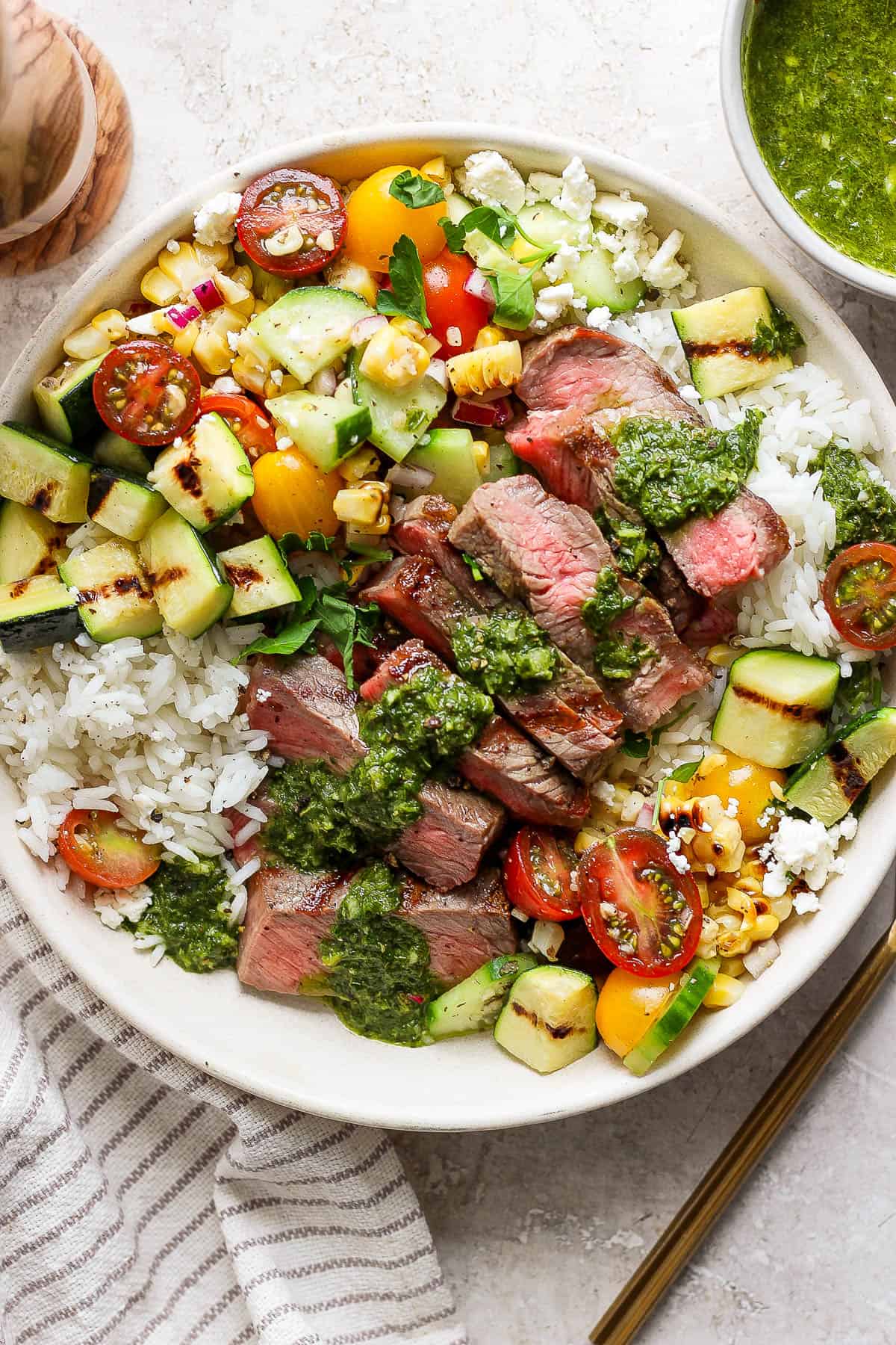 Steak rice bowl topped with chimichurri.