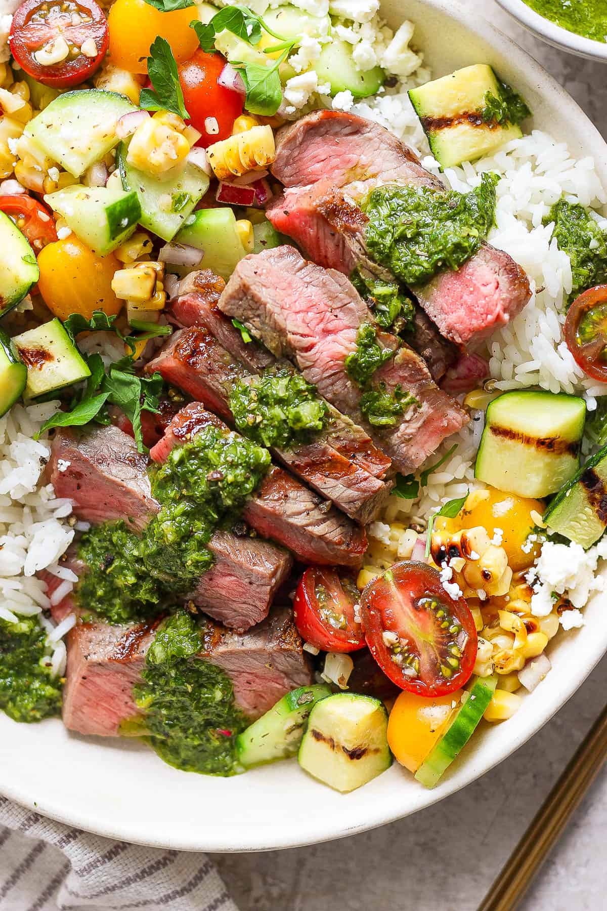 The corn salad added to a steak rice bowl.