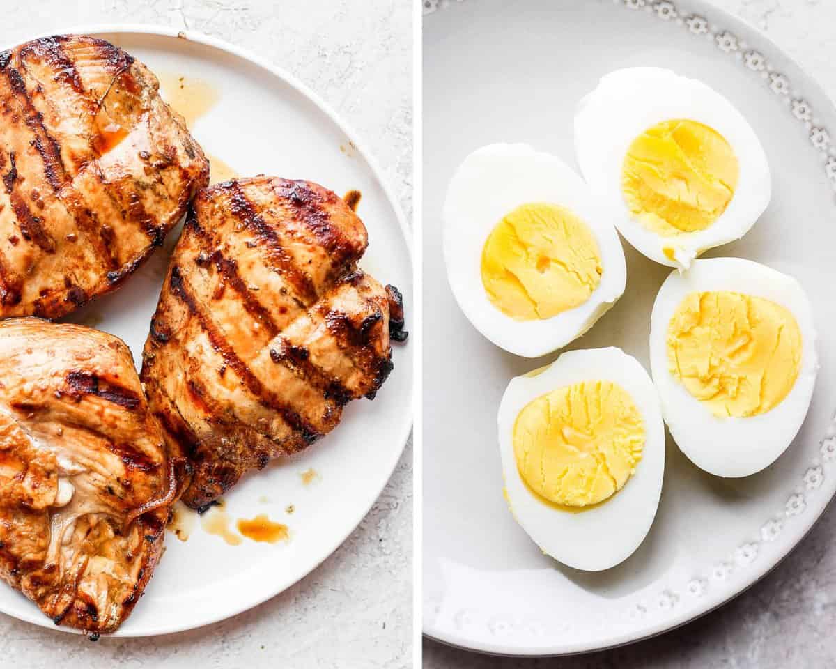 Three grilled chicken breasts on a plate alongside two hard boiled eggs sliced down the middle.
