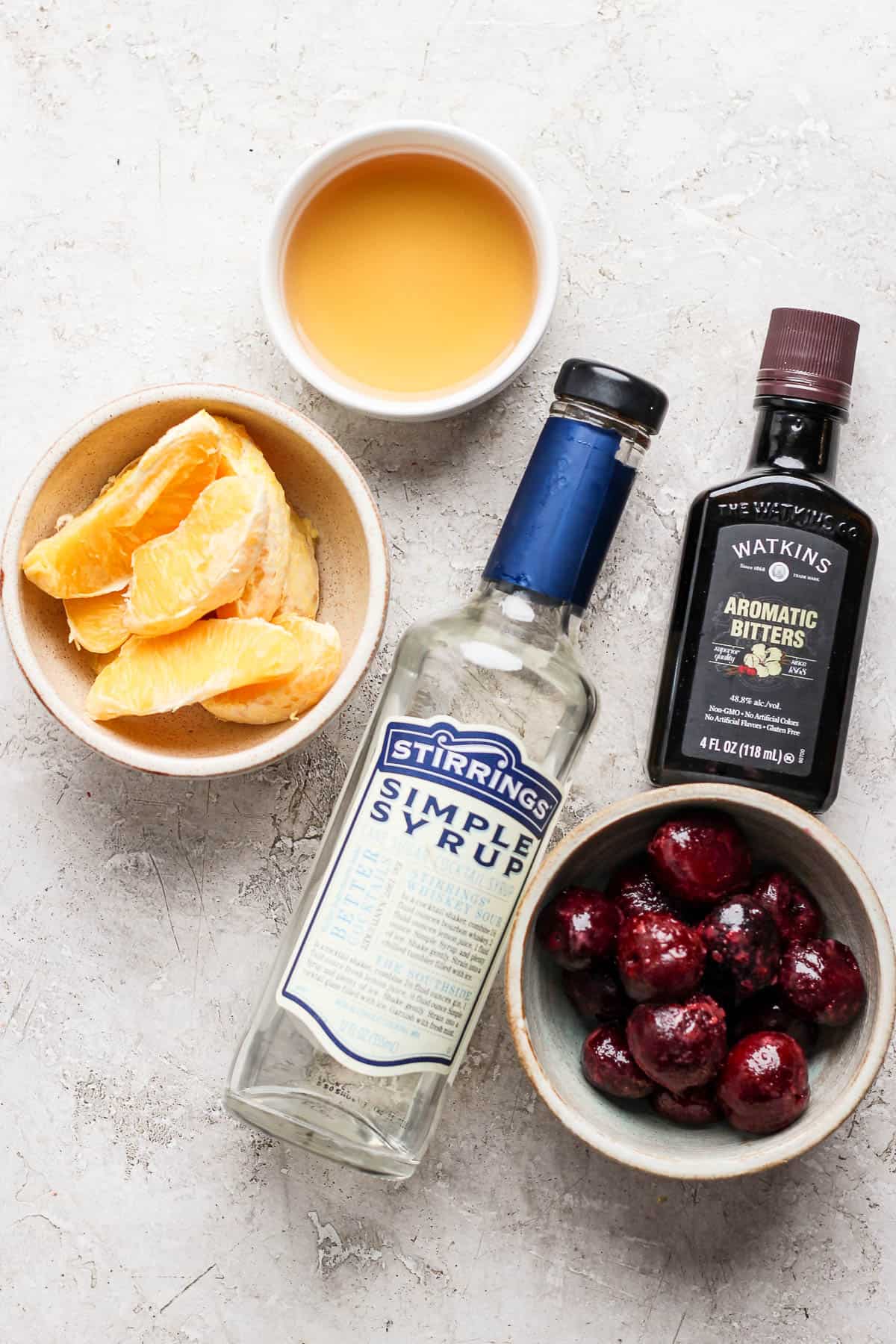 Ingredients for a frozen old fashioned in separate bowls.