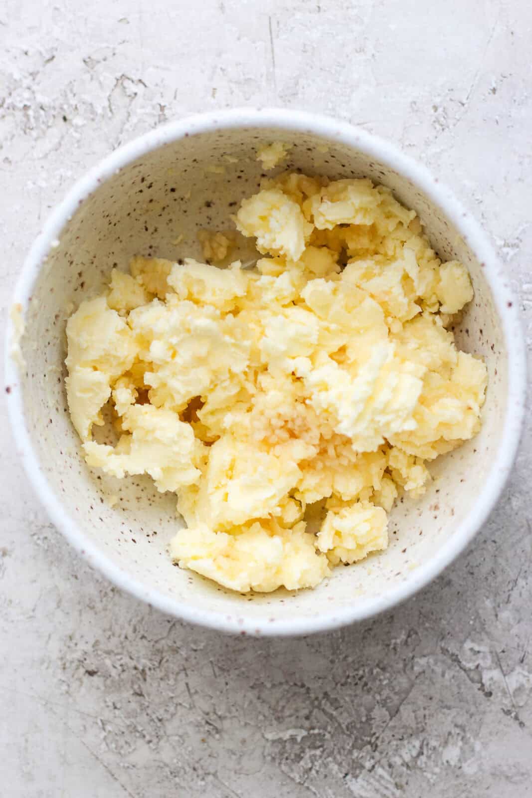 Garlic butter in a small bowl before being used in a Blackstone shrimp fried rice.