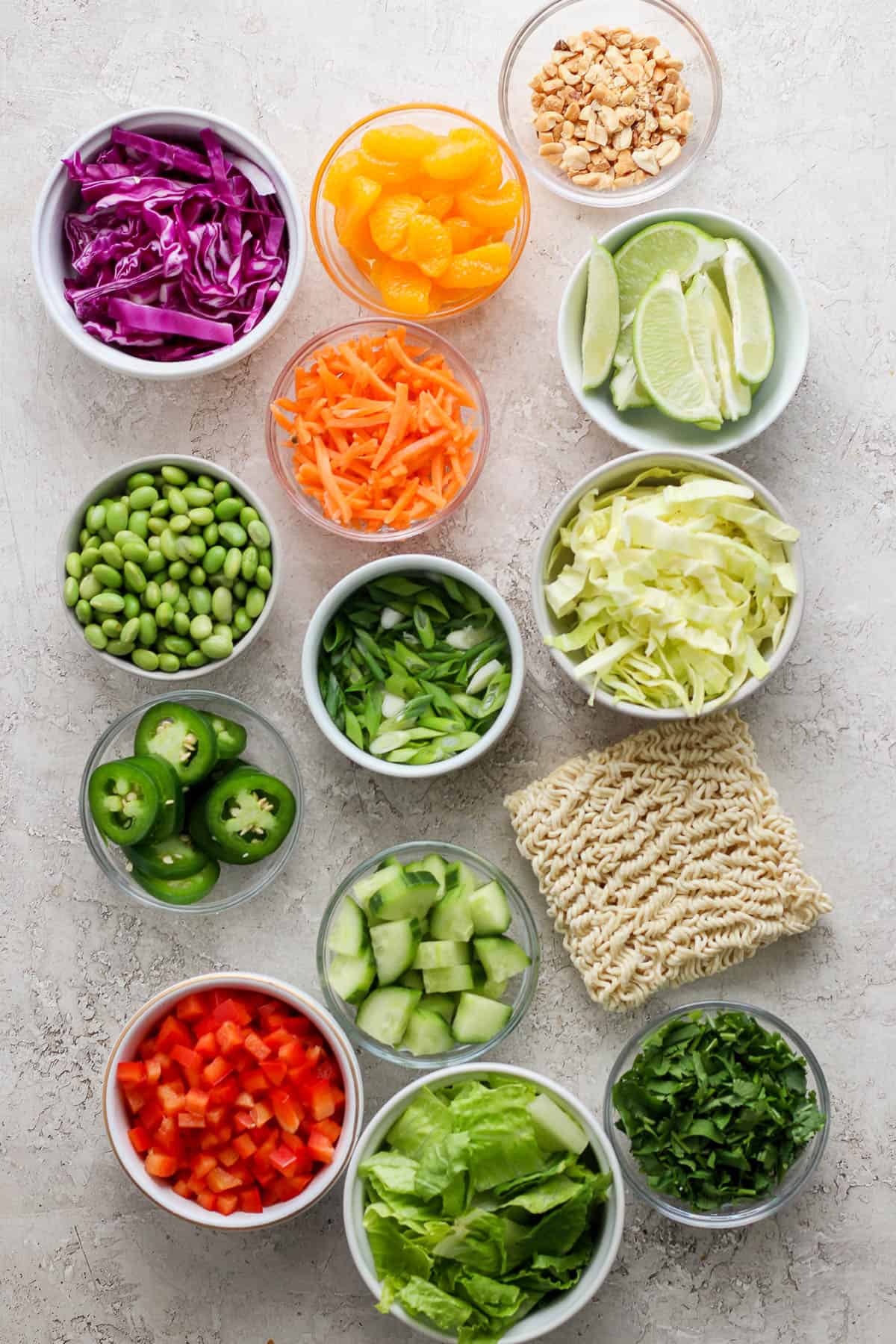 Ramen salad ingredients in separate bowls.