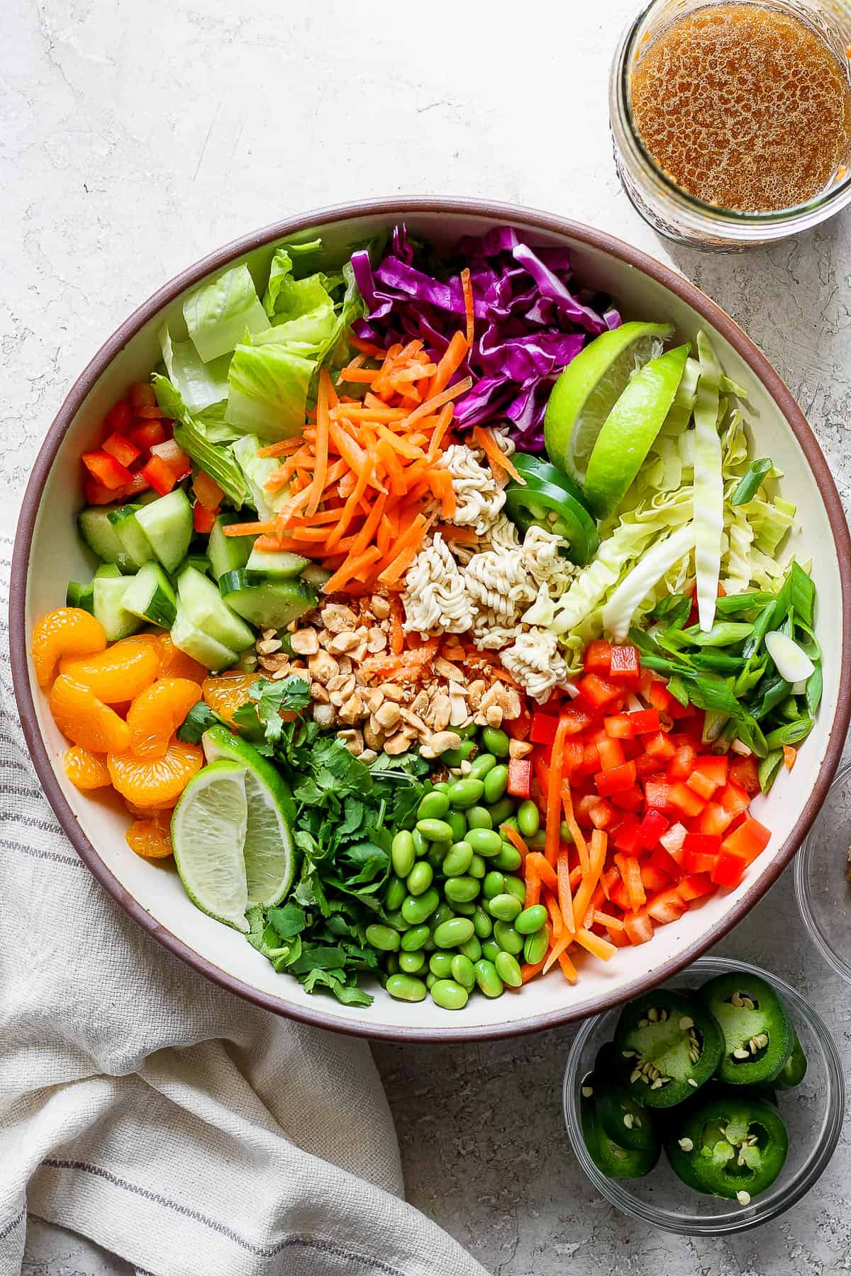 All the ramen salad ingredients separated in a large bowl.