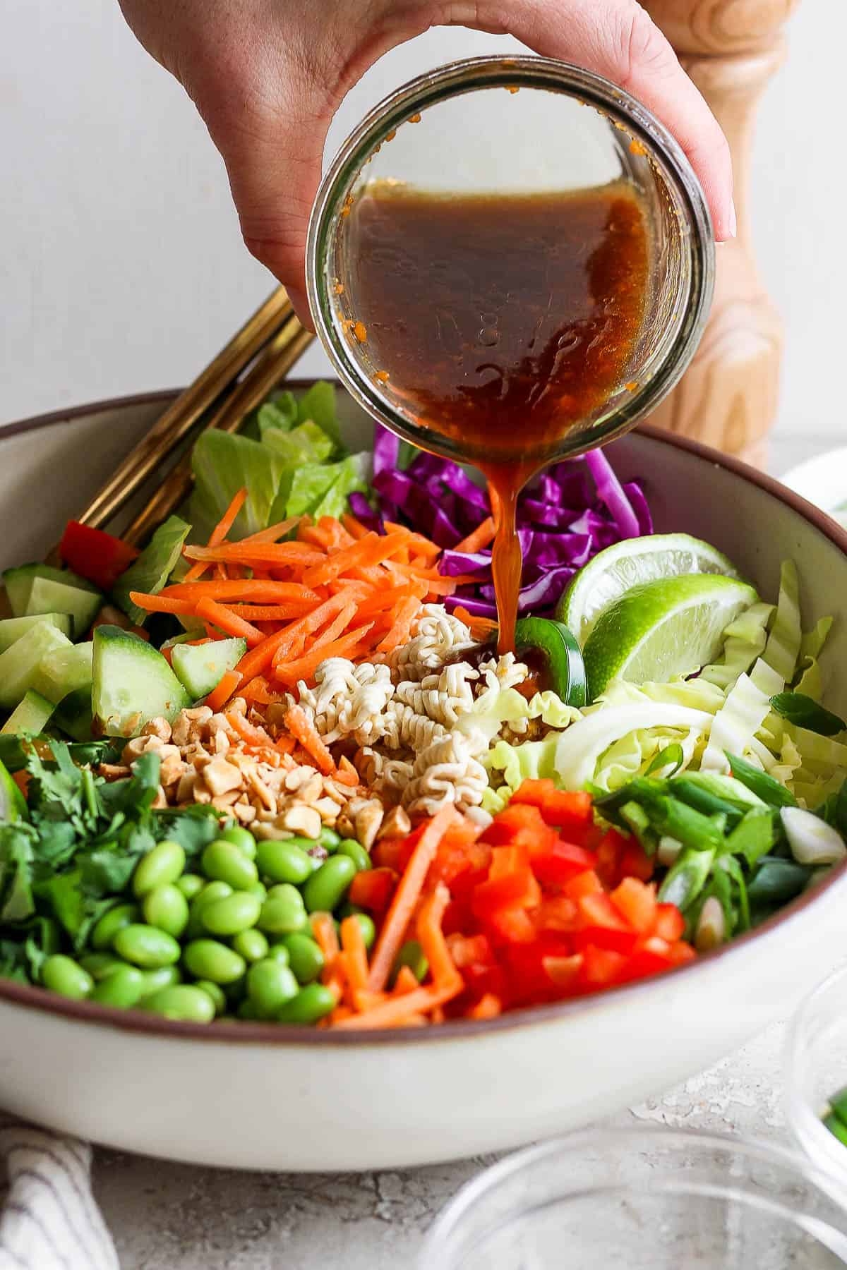 The sesame ginger dressing being poured on top.