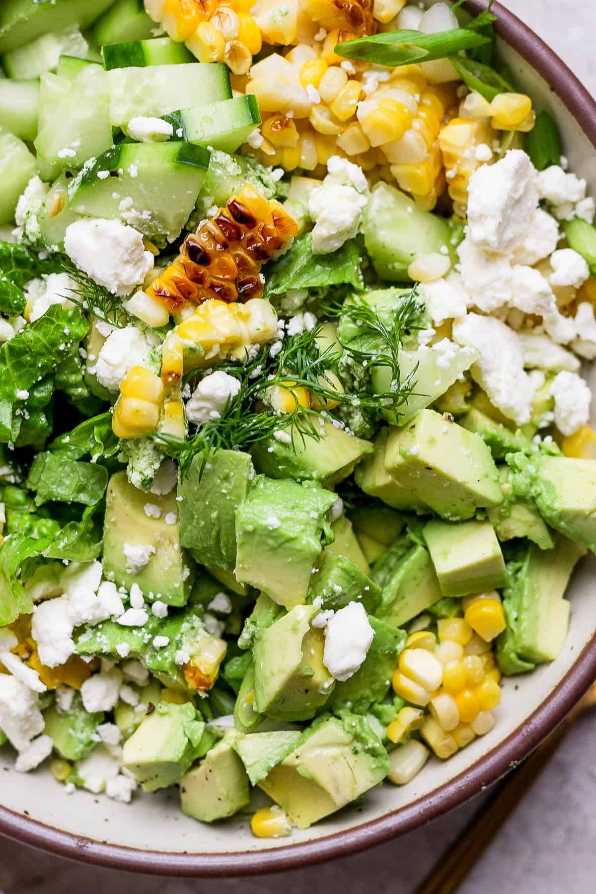 A fully mixed avocado salad in a bowl.